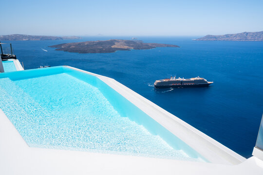 White architecture in Santorini island, Greece. Swimming pool with sea view. Blue sea and the blue sky at sunny day.