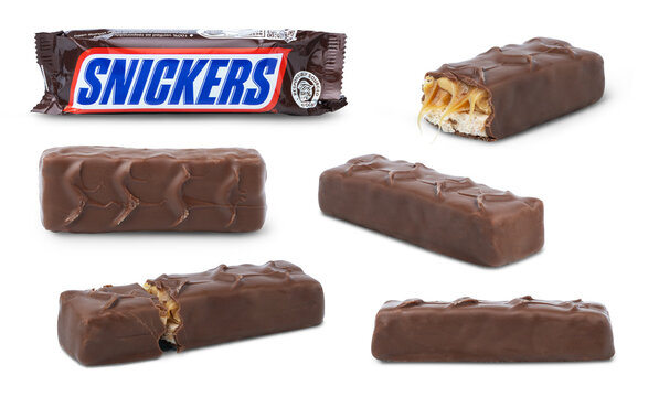 KYIV, UKRAINE - April 01, 2026 - Chocolate snickers bar in the package isolated in different positions, different view. Unwrapped snickers chocolate bar. Broken chocolate bar.