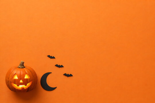 Halloween jack-o'-lantern pumpkin with black bats and crescent moon cutout on orange background halloween jackolantern celebration decoration silhouette minimalist seasonal background