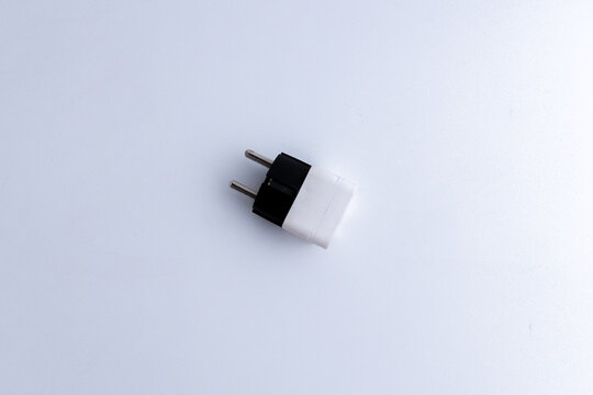 White universal electrical plug adapter isolated on a white background