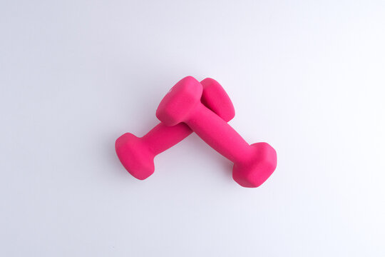 Pink small hand weight dumbbells for fitness isolated on white background