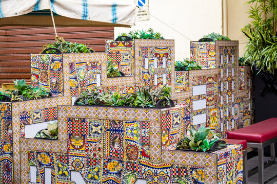 Decorative flower planters covered with colorful Sicilian majolica tiles at Mercato di Ballaro in Palermo Sicily Italy brighten the street. Traditional ceramic craftsmanship and cultural tourism