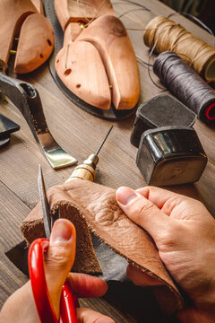 cobbler tools in workshop dark background close up