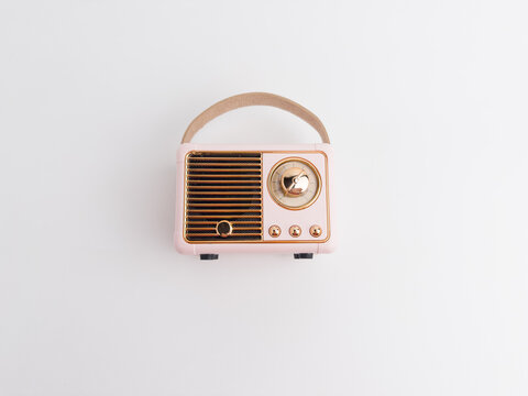 Cute pink vintage retro mini radio bluetooth speaker isolated on a white background