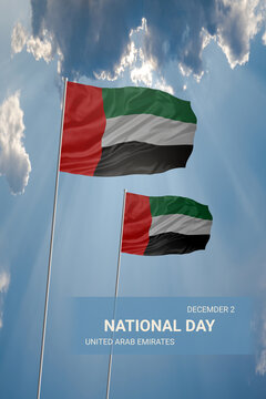 Two flags of United Arab Emirates in blue sky with clouds for National holiday