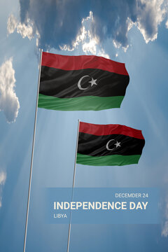 Two flags of Libya in blue sky with clouds for National holiday