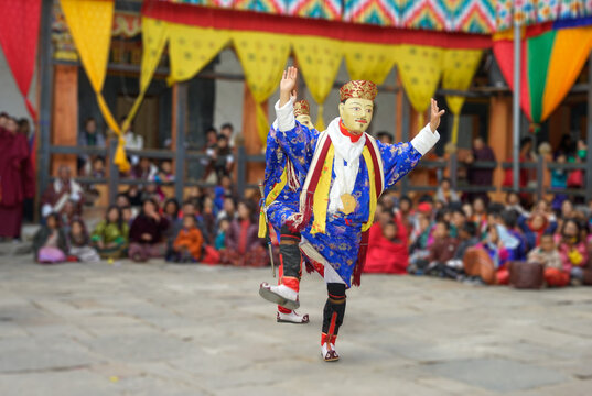 Bhutan, in the village of Bumthang, a monk mask dancer in his colourful costume dances at the festival of Jakar.
