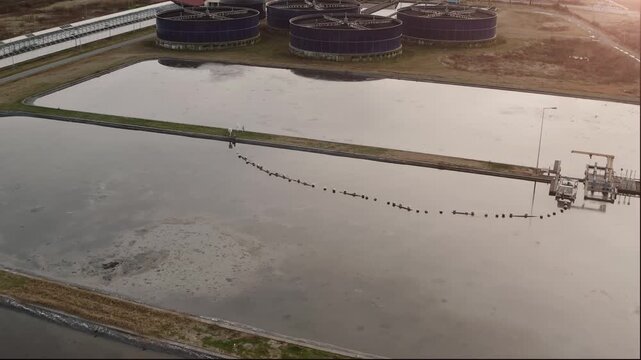 Wastewater treatment facility with basin infrastructure, water management, environmental engineering and sustainability, aerial view.