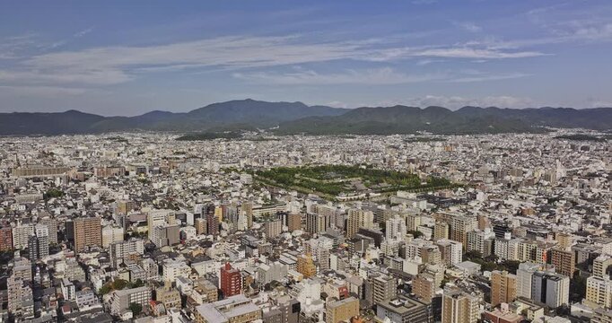 Kyoto Japan Aerial v10 flyover above Nijo Castle and Nishirokkakucho, revealing Nakagyo, Kamigyo and Ukyo city districts against mountain ridges - Shot with Mavic 3 Pro Cine - Oct 7th 2023