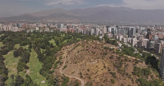 Santiago Chile Aerial v19 low orbit above Las Condes and Barrio El Golf, revealing Vitacura neighborhoods, green hills and Andes Mountains - Shot with Mavic 3 Pro Cine - Jan 20th 2025