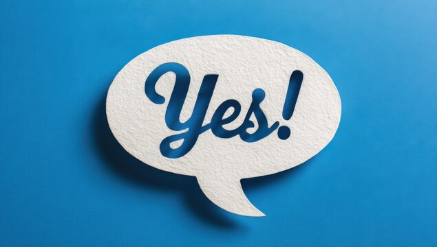 White paper speech bubble with the word yes written on a textured blue background positive affirmation agreement communication dialogue conversation background minimalist decision