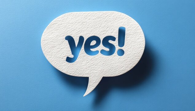 Small white paper cut yes speech bubble icon isolated on a blue background with communication affirmative agreement approval positive acceptance confirmation dialogue background