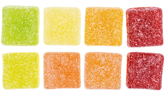 Assortment of colorful square gummy candies coated in sugar, isolated on transparent background