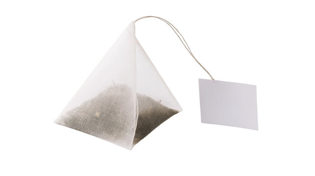 Pyramid tea bag with dry tea leaves and white paper tag, isolated on transparent background