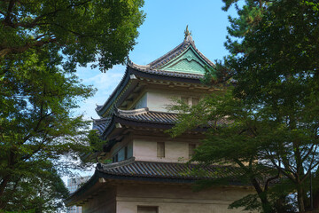 Naklejka premium Tokyo, Japan - Oct 01 2024, panoramic view of the Fujimi-yagura watchtower surrounded by tree foliage, against the blue sky, part of the Tokyo Imperial Palace, Tokyo, Japan