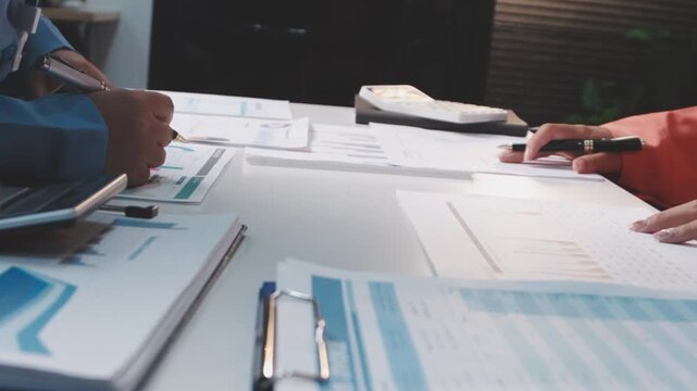 Asian business adviser meeting to analyze and discuss the situation on the financial report in the meeting room.Investment Consultant, Financial advisor and accounting concept
