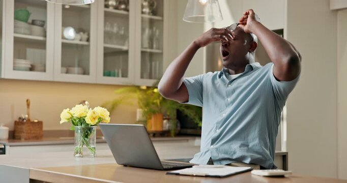 Laptop, home and black man with eye strain for financial pressure, burnout or overworked in kitchen. Tired, male person or glasses with computer and stress for finance expenses or bills in house