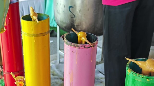 Mold big candles for Buddhist Lent. Candle casting ceremony in Thailand.