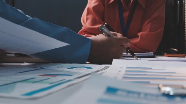 Asian business adviser meeting to analyze and discuss the situation on the financial report in the meeting room.Investment Consultant, Financial advisor and accounting concept