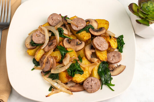 sausages  with sauteed vegetables and potato wedges