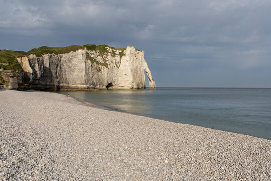 Aval Cliff and natural arch seen from Etretat beach on the Alabaster Coast, Normandy, France