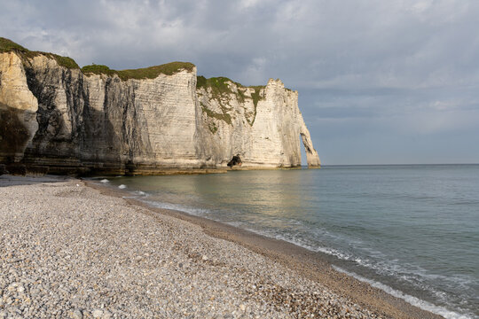Aval Cliff and natural arch seen from Etretat beach on the Alabaster Coast, Normandy, France