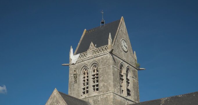 The Church of Sainte-M&egrave;re-&Eacute;glise in Normandy displays a hanging doll, commemorating the American paratrooper John Steele. Normandy, France