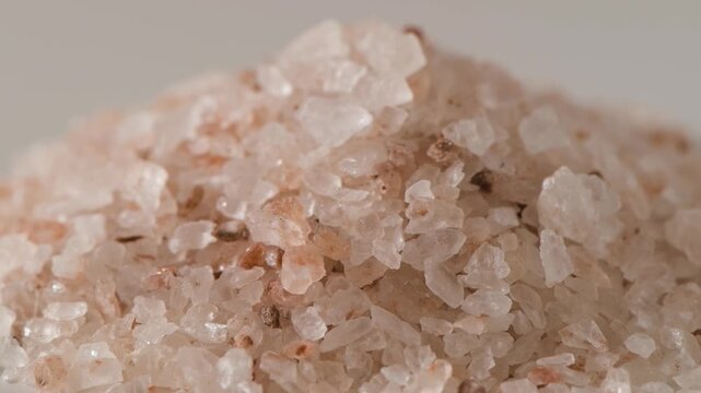 Pink rock salt crystal close up macro texture with natural mineral formation
