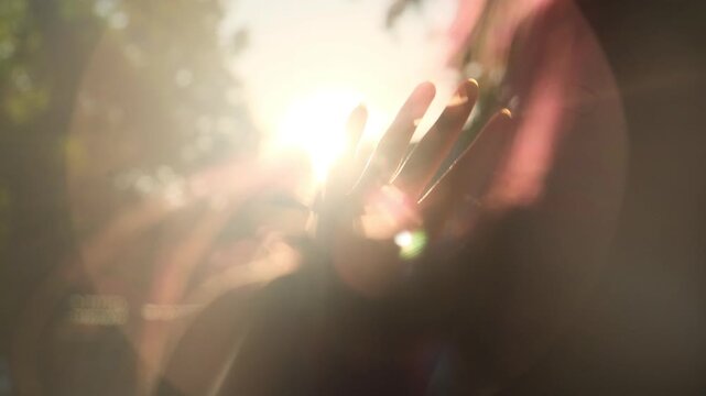 Female hand shields the eyes from the bright summer sun. Heat wave, drought, extreme heat, sun protection, climate change and high air temperature.