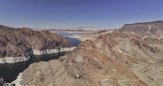 Hoover Dam Nevada Aerial v16 flyover above Black Canyon and Lake Mead, revealing rocky mountains and the reservoir's white shoreline - Shot with Mavic 3 Pro Cine - Apr 16th 2024