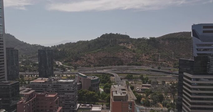 Santiago Chile Aerial v11 low flyover above Las Condes and Providencia, revealing hillside parkland, forested slopes and urban highway - Shot with Mavic 3 Pro Cine - Jan 20th 2025