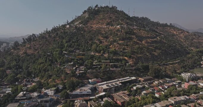 Santiago Chile Aerial v60 rising flyover above Bellavista and Recoleta, revealing Santiago Zoo, San Cristobal hillside and cityscape - Shot with Mavic 3 Pro Cine - Jan 24th 2025
