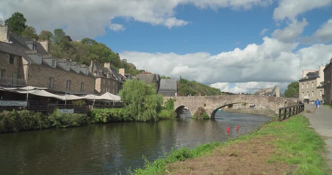 The port of the medieval city of Dinan with the old stone bridge that crosses the Rance River in Brittany, France