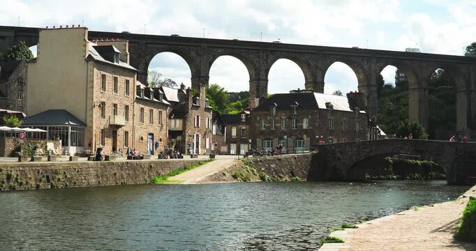The port of the medieval city of Dinan with the old stone bridge that crosses the Rance River in Brittany, France