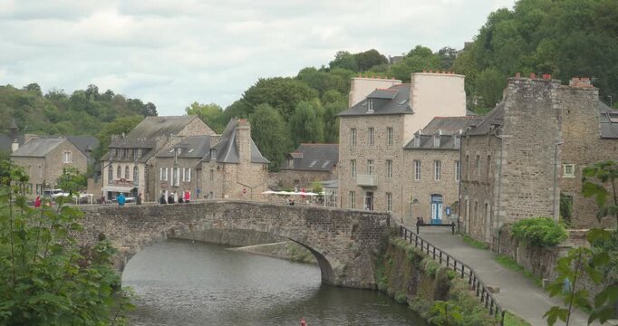 The port of the medieval city of Dinan with the old stone bridge that crosses the Rance River in Brittany, France