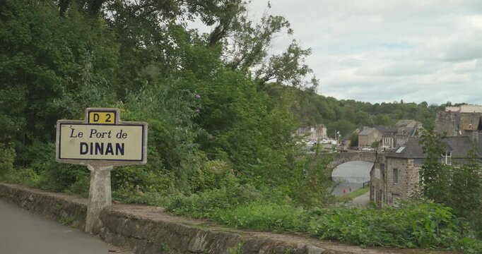 The port of the medieval city of Dinan with the old stone bridge that crosses the Rance River in Brittany, France