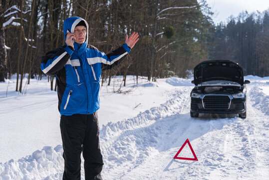 Driver call for roadside assistance after winter car breakdown