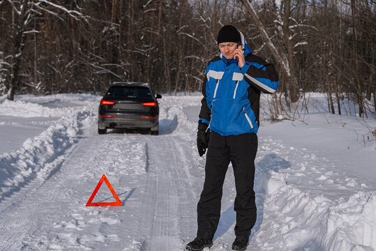 Driver call for roadside assistance after winter car breakdown