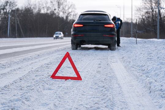 Emergency car breakdown warning on snowy winter road