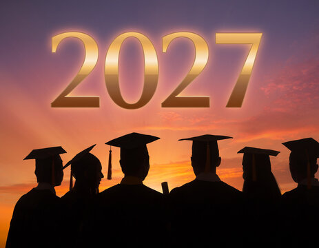 Silhouettes of graduates wearing academic caps against a sunset sky with 2027 graduation students academic mortarboards silhouette education knowledge achievement university commencement