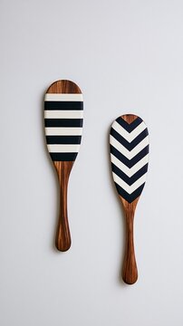 Decorative wooden paddles featuring minimalist black and white geometric patterns for modern home decor