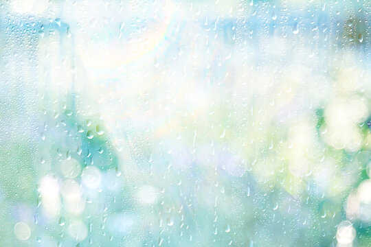 Light green gradient raindrops on glass abstract blurred background gentle summer soft green