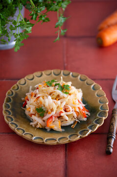 Fermented sauerkraut on plate on red tiles
