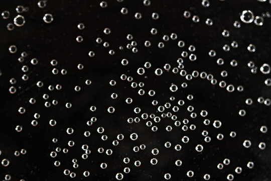 Air bubbles on a black background, texture for overlay, liquid