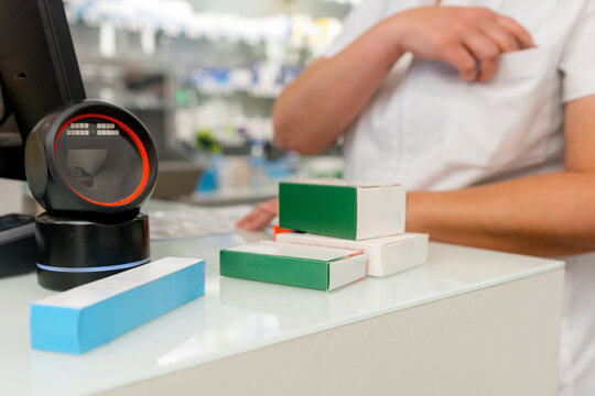 Pharmacy counter with medicine boxes and barcode scanner