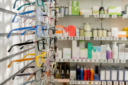 Eyeglass frame display beside cosmetic products in pharmacy