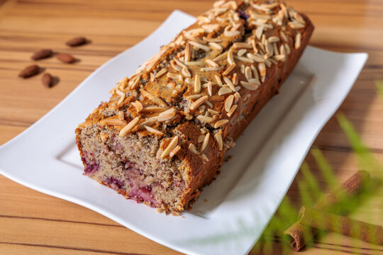Homemade Almond Berry Loaf Cake on White Plate, Fresh Baked Dessert with Sliced Almonds