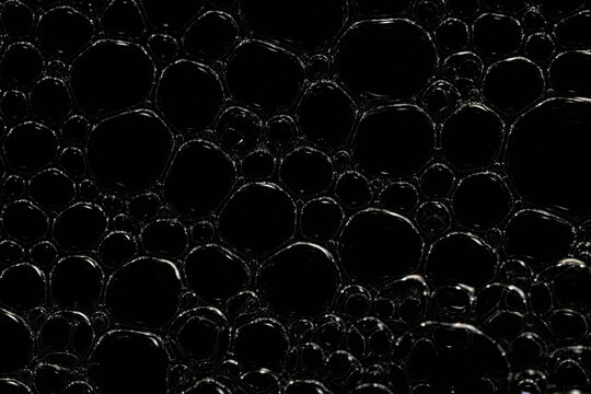 texture bubbles on a black background, soap bubbles, abstract circles, shape abstraction in full screen
