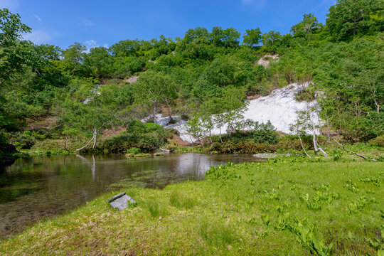 Yuno Pond with lingering snow at Daisetsu Kogen Ponds, Daisetsuzan National Park, Hokkaido, Japan
