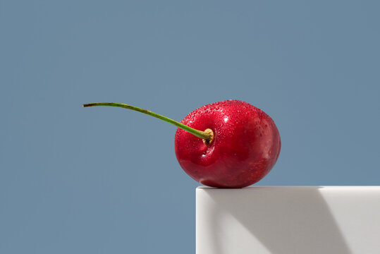 Jerte Picota cherry with water droplets on blue background